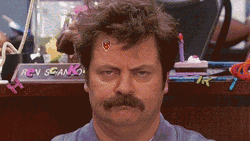 a man with a mustache has a sticker on his forehead that says ' ron swanson '