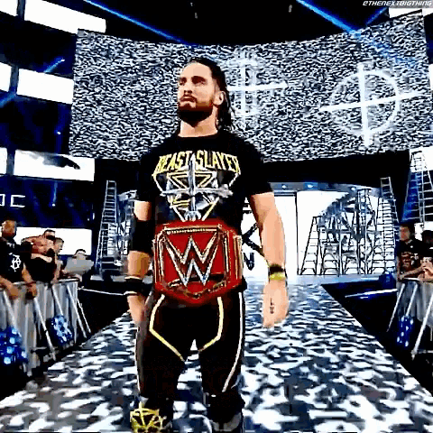 a wrestler is walking down a ramp with a wrestling belt on .