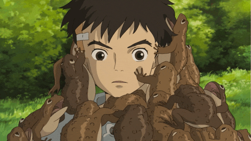 a boy is surrounded by frogs and has a bandage on his head