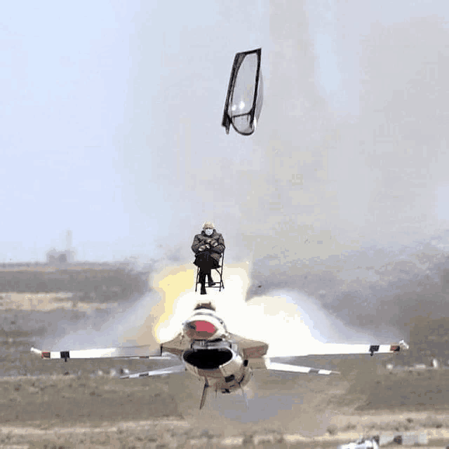 a man in a chair is sitting on top of a jet