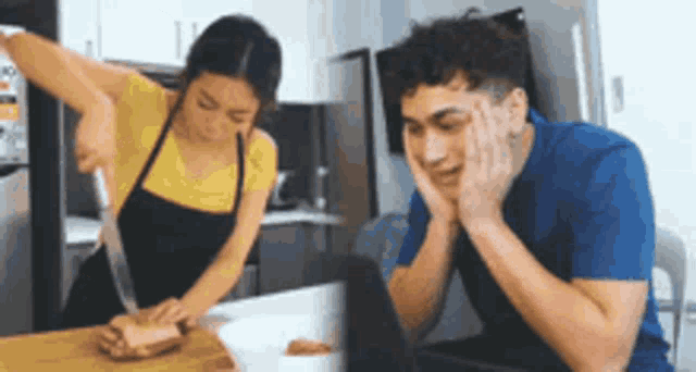 a woman is cutting a piece of meat while a man is sitting at a table looking at a laptop .