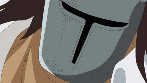 a close up of a helmet with a black t on it