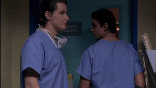 two doctors are standing in front of a door that says pediatric oncology