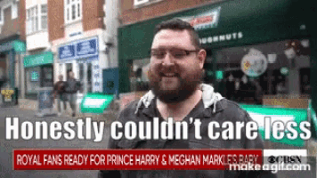 a man with glasses and a beard is standing in front of a krispy kreme doughnut shop