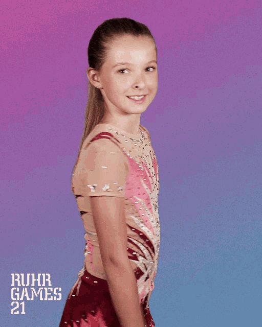 a girl giving a thumbs up in front of a ruhr games 21 poster