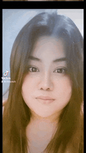 a close up of a woman 's face with a tik tok watermark