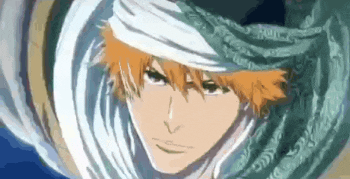 a close up of a person 's face with a white scarf around their head .