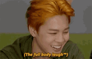 a person with red hair is covering their face with their hands and says the full body laugh .