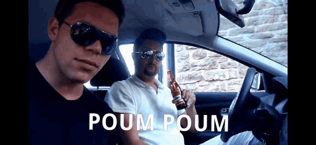 two men are sitting in a car with poum poum written on the bottom