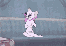 tom and jerry are sitting on a couch with a cat wearing a pink bow .