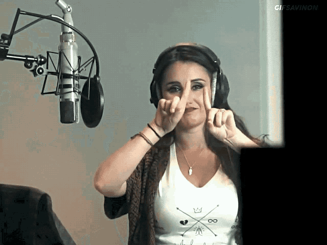 a woman wearing headphones stands in front of a microphone with the words gissavino on the bottom