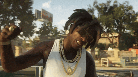 a man with dreadlocks wearing sunglasses and a gold chain