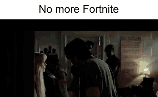 a man and a woman are standing next to each other in a room with a sign that says `` no more fortnite '' .