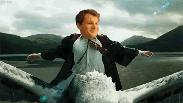 a man in a suit and tie is riding on the back of an eagle .