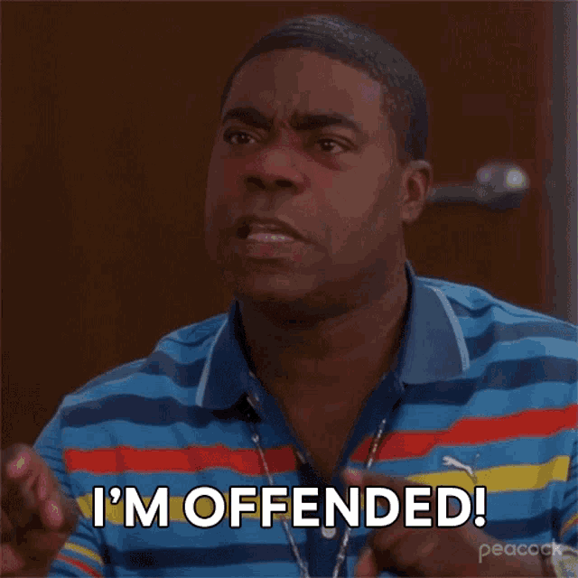 a man wearing a striped shirt is saying i 'm offended
