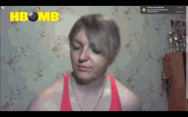 a woman in a red tank top is on a screen that says ' hbomb ' on it