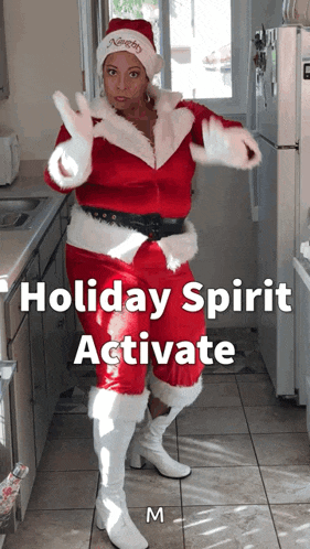 a woman dressed as santa claus in a kitchen with the words holiday spirit activate