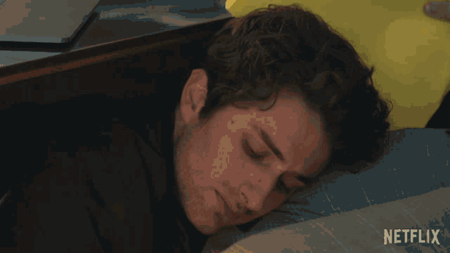a man sleeping on a bed with netflix written on the bottom