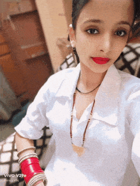 a woman taking a selfie with a phone that says vivo on it