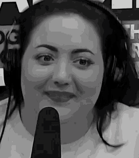 a black and white photo of a woman wearing headphones and a microphone