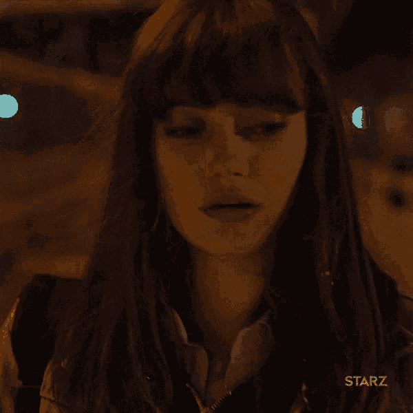 a close up of a woman 's face with a starz logo on the bottom