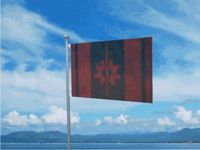 a canadian flag is flying in the wind