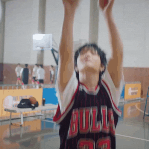 a basketball player in a bulls jersey shoots a ball