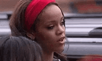 a woman wearing a red headband is talking to another woman in a car .