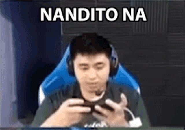 a man wearing headphones is sitting in a chair playing a video game .