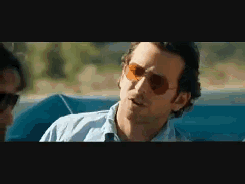 a man wearing sunglasses is sitting in a car