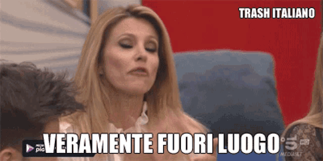 a woman sitting on a couch with the words trash italiano above her