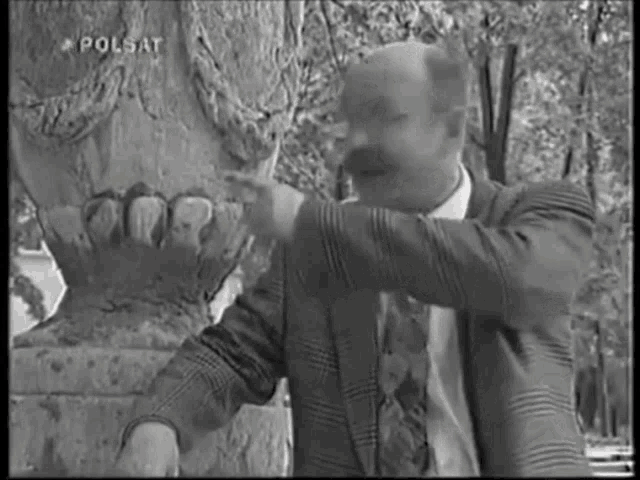 a black and white photo of a man with the words polsat on the bottom right