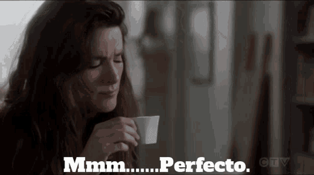 a woman drinking a cup of coffee with the words " mmmm perfecto " written below her