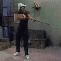 a person holding a stick in a room with a couch