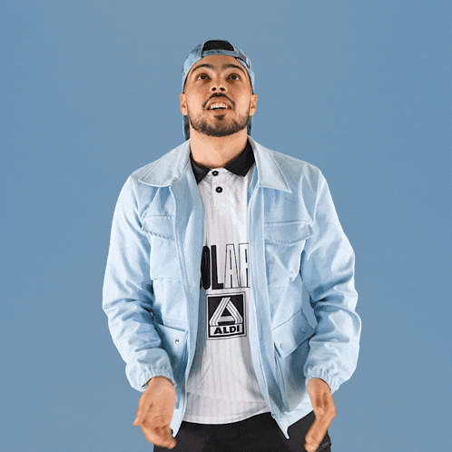 a man wearing a light blue jacket and a white shirt with the word aldi on it
