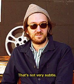 a man with a beard wearing sunglasses and a hat says that 's not very subtle