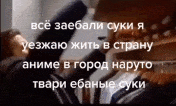 a man is standing in front of a closet with clothes hanging on it and a foreign language written on it