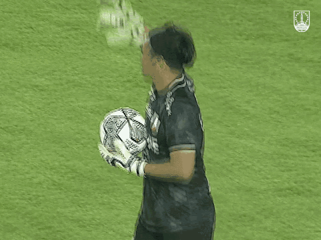 a soccer player wearing number 1 holds a ball
