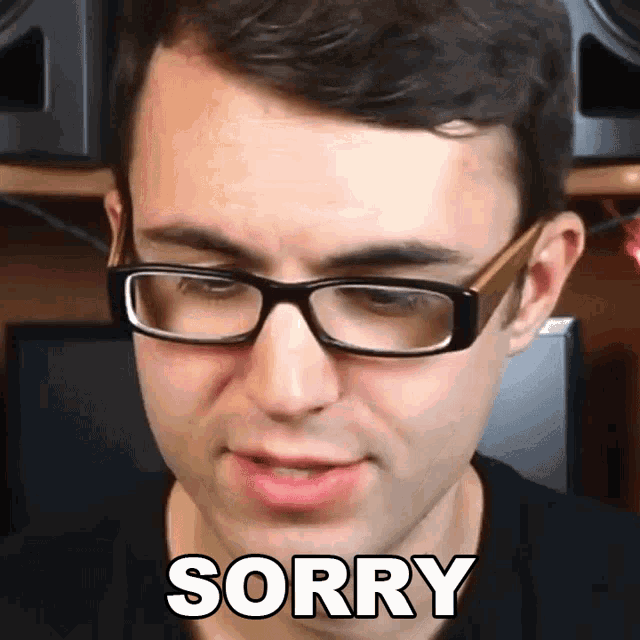 a man wearing glasses says sorry in white letters on his face