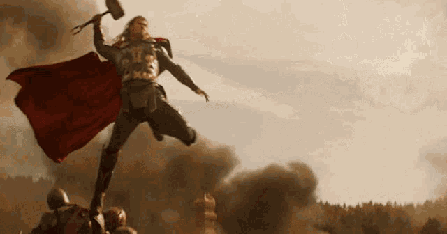 thor is holding a hammer in his hand and jumping in the air .