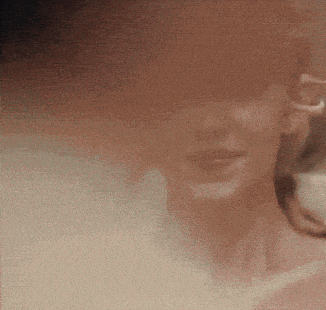 a blurred image of a person 's face with a few spots of light on it