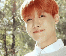 a close up of a person 's face with red hair .