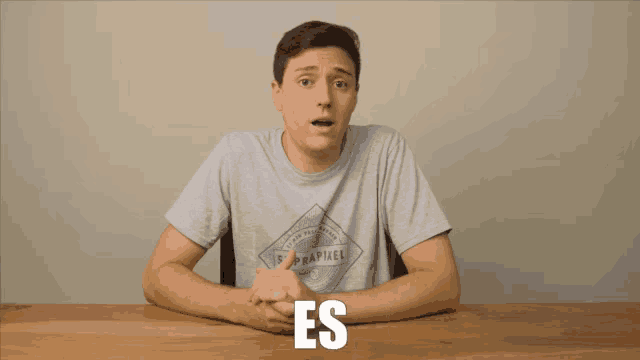 a man sitting at a table with the word espectacular written on the bottom