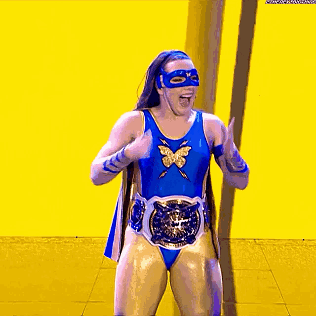 a woman in a superhero costume is giving a thumbs up sign