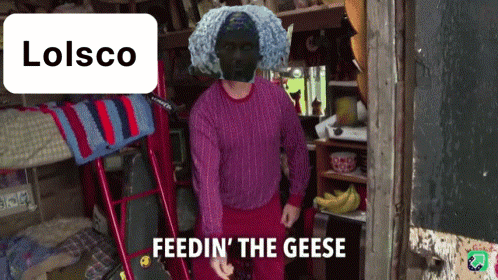 a man in a pink sweater is standing in front of a door with the words feedin ' the geese written above him