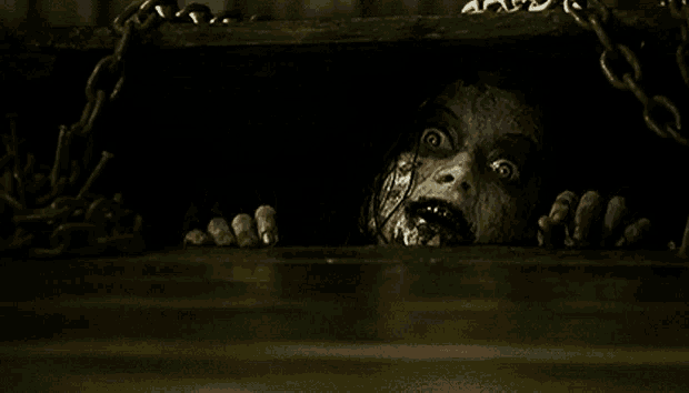 a scary face is sticking its head out of a hole