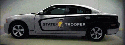 a state trooper car is sitting in a garage