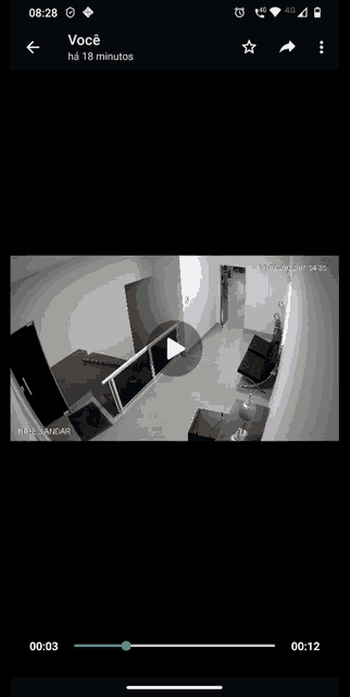 a phone screen shows a video of a room with the time of 18:28
