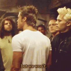 a group of men are standing next to each other and one of them is saying but we won t .
