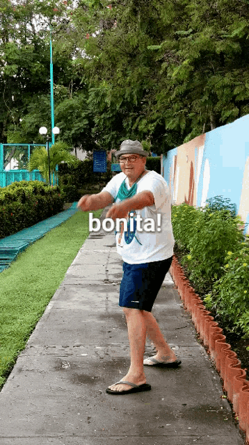a man standing on a sidewalk with the word bonita on the bottom right